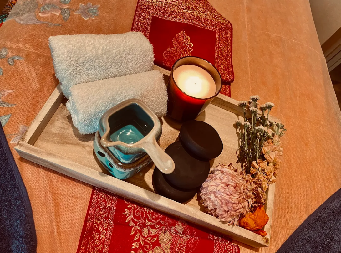 Massage therapy accessories - towels, candles, and hot stones